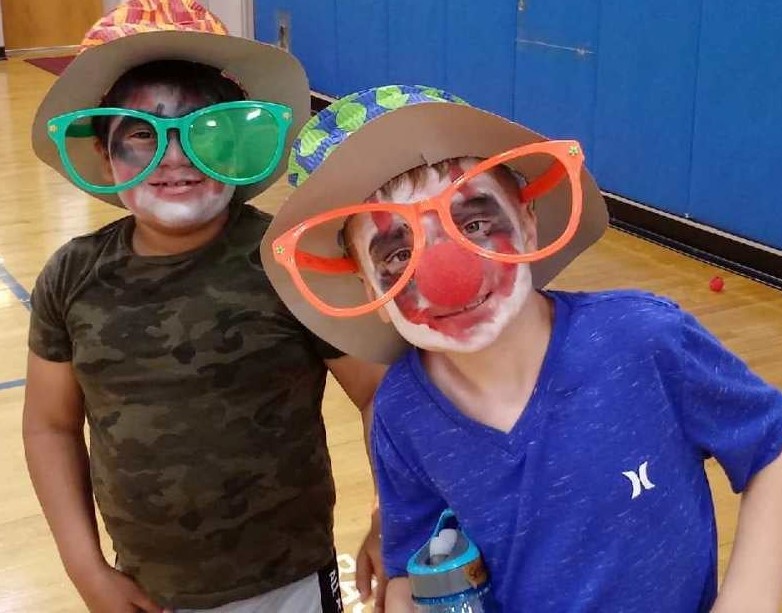 Image of boys in face paint and wacky glasses.